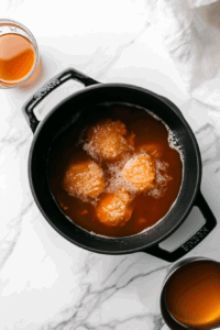 This image shows the mixture being brought to a boil before simmering for 15–20 minutes.