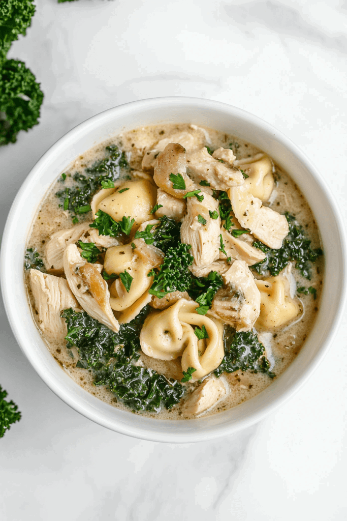 chicken-and-kale-tortellini-soup-in-a-white-bowl