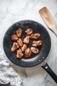 This image shows chicken frying for 3 minutes per side