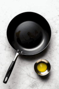 This image shows a large sauté pan heating over medium-high heat for 2 minutes.