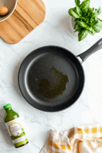 This image shows a skillet being heated on the stovetop, ready for cooking.