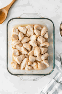 This image shows chicken pieces being layered evenly in the baking dish.