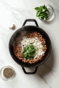 This image shows remaining ingredients stirred in, except for the cabbage, and brought to a boil for making Keto Crockpot Goulash