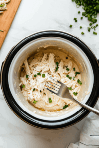 This image shows the cooked chicken shredded and mixed with cream cheese