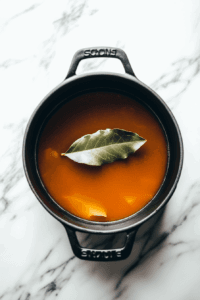 simmering-the broth with with-a-bay-leaf slowly