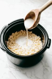 whisking-the-evaporated-milk-and-eggs-and-adding-to-macaroni to make it creamier and richer in taste