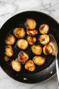 This image shows chicken cooking in a single layer in the sauté pan for about 3 minutes.