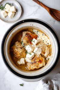 This image shows cream cheese pieces distributed over the chicken