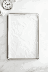 This image shows a baking tray neatly lined with parchment paper.
