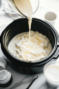 this image shows milk-heavy-cream-condensed-milk-and-vanilla-extract being mixed together for hot chocolate