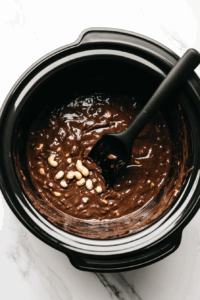 this image shows melting of nuts-and-condensed-milk in a black bowl