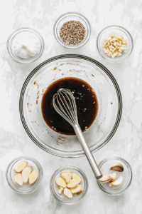 This image shows sauce ingredients being whisked together until well combined