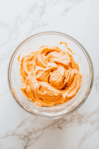 This image shows an electric mixer blending the sweet potato filling until it reaches a creamy and smooth texture.