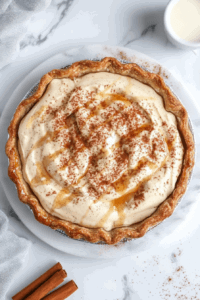 This image shows melted vegan butter being drizzled over the pie, followed by a sprinkle of cinnamon-sugar, preparing it for baking.