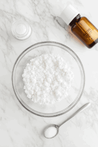 This image shows powdered sugar and vanilla extract being added to the whipped chickpea liquid, enhancing the flavor of the vegan whipped cream.