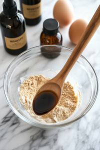 Wet ingredients, including eggs, milk, and vanilla, being added to the dry mixture to create a smooth chocolate cake batter.