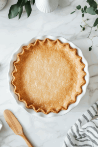 this image shows The crust is baked to a golden perfection, providing a sturdy and flavorful foundation for the pie.