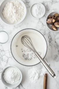 This image shows a saucepan with ingredients being whisked together to create the creamy pudding filling for the vegan banana cream pie.