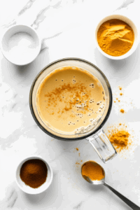 This image shows a creamy custard mixture being poured into a perfectly shaped pie crust, ready to be baked into a delicious vegan custard pie.