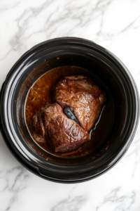 This image shows a meat thermometer being inserted into the pork loin to check the internal temperature, ensuring it’s cooked to perfection.