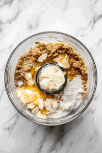 This image shows the process of combining the ingredients for the Vegan Treacle Tart pastry dough, ensuring a smooth and flaky base for the tart.