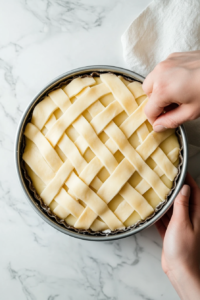 This image shows the edges of the Linzer Torte being neatly finished with patterned dough, adding a touch of elegance to the dessert.