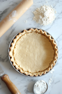 This image shows the dough being pressed evenly into the cake tin to create the firm and structured base for the Vegan Linzer Torte.