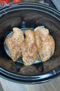 Layer the seasoned chicken breasts in the bottom of the crockpot