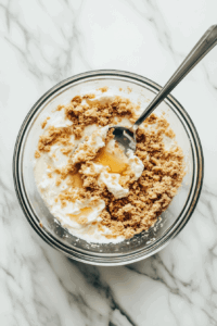 this image shows The process of preparing the crust mixture with fine crumbs and vegan butter for the Vegan Chocolate Meringue Pie base.