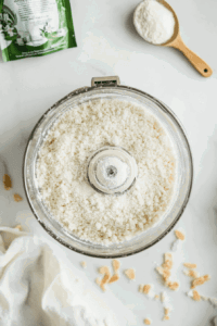 This image shows a food processor with flour and salt being blended together to form the base of the tart crust.