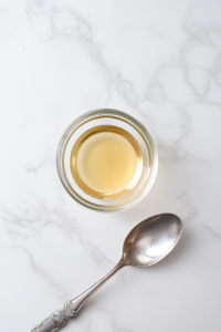 This image shows a bowl of ground flaxseeds mixed with water, forming a gel-like consistency to act as an egg replacement.