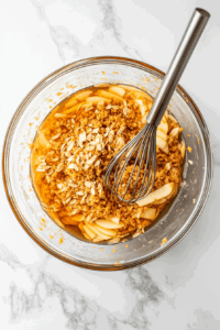 This image shows the ingredients for the treacle filling being mixed together to create a smooth and sticky mixture for the Vegan Treacle Tart.