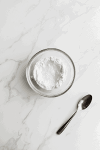 This image shows the preparation of a flax egg, combining ground flax seeds with water, as a vegan egg substitute for the filling of the Vegan Treacle Tart.