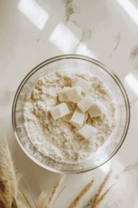 This image shows ingredients being processed in a food processor to form a smooth and even dough for the vegan lemon meringue pie crust.