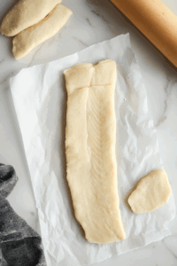rolling-dough-into-fillet-shapes-in-smooth-manner