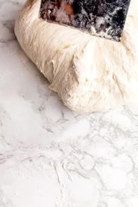 Scrape the dough onto floured parchment paper