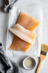 This image shows the edges of the dough being folded and pressed together to completely seal the vegan cheese and ham inside.