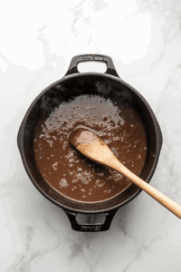 This image shows the black bean soup simmering gently over low heat, allowing the flavors to meld together as it cooks.