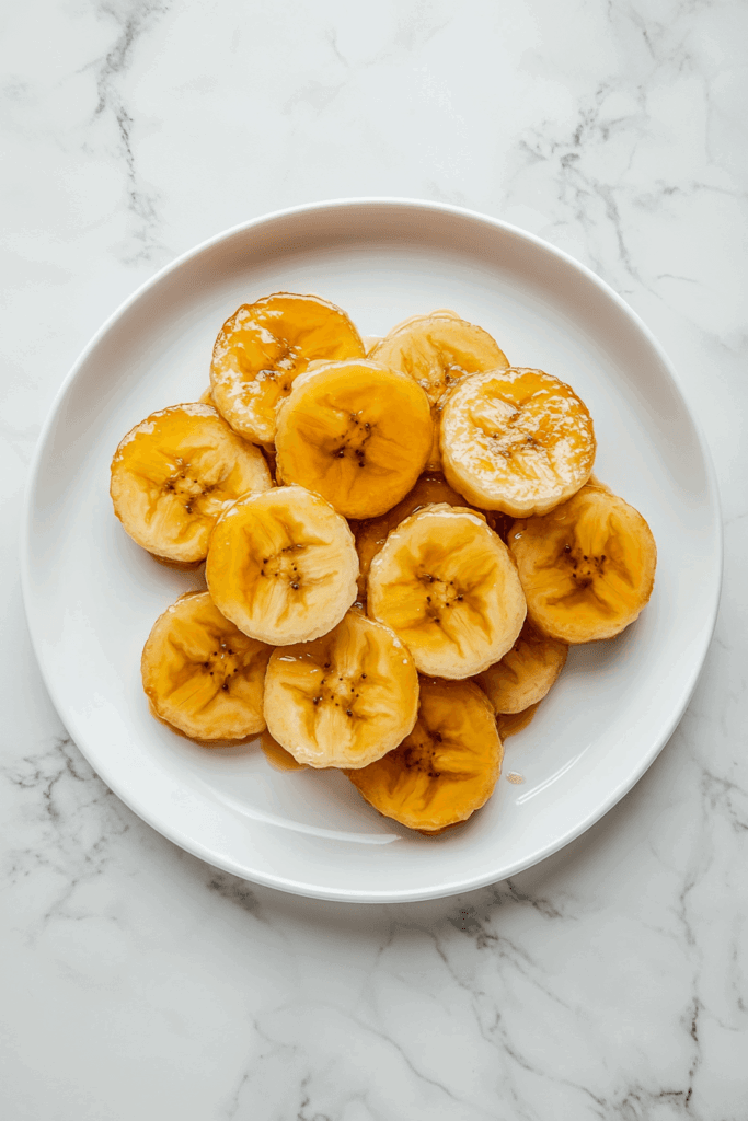This image shows a decadent slow-cooked banana upside-down cake, featuring perfectly caramelized banana slices on top.