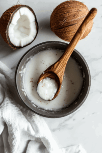 this image shows coconut milk and coconut oil gently heating in a saucepan until bubbling, forming the rich base for the chocolate truffle pie filling.