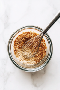 This image shows the almond flour mixture being incorporated into the melted cheese mixture, creating a sticky pizza dough.