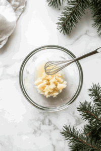 This image shows sauce ingredients being combined in a small bowl with a spoon, then stirred into a vibrant vegetable mixture, blending the flavors evenly for a cohesive dish.