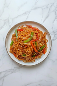 This image showcases a final serving of Vegetable Chow Mein, garnished and ready to be enjoyed.