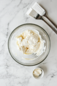 This image shows a mixing bowl with mayonnaise, buttermilk, and dry seasoning being combined, the first step in creating a flavorful Wingstop-style ranch dressing.