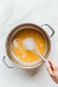 This image shows the broth coming to a rolling boil, preparing it for the addition of dumplings.