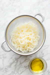 cooked-noodles-being-drained-in-a-colander