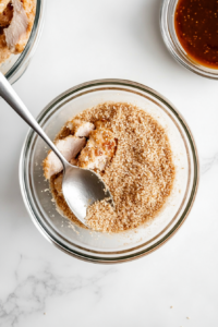 This image shows a bowl filled with golden panko breadcrumbs, prepared to give the chicken katsu its signature crunch.