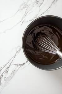 This image shows a pot of roux that has been cooked to a deep chocolate brown color, an essential step for developing the bold, nutty flavor of Cajun gumbo.