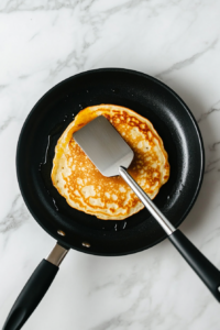 flipping-a-buttermilk-pancake-to-cook-evenly-on-both-sides
