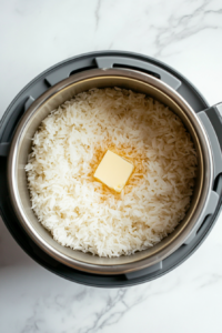 This image shows a pot of rice being cooked, creating a light and fluffy base to serve with the flavorful spicy chicken.